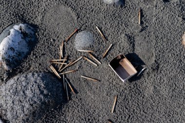 Burnt match sticks on the beach