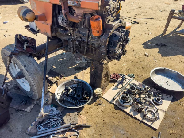 stock image Mechanic dismantle tractor engine to repair gearbox and transmission: 04 December 2023 - Swat, Pakistan.