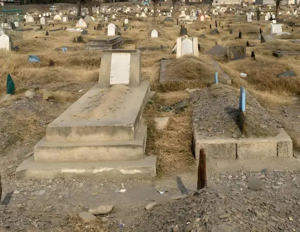Gravestones and graves at Muslim cemetery in Pakistan
