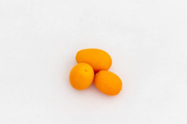 Ripe kumquat fruit over white background clipart