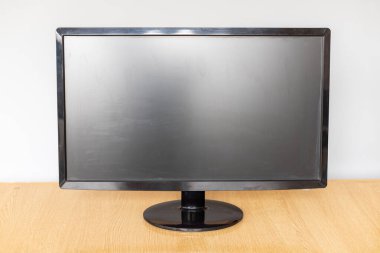 Ahşap masadaki parlak siyah monitör