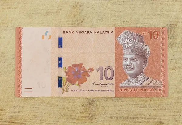 stock image Malaysian 10 Ringgit banknote on a wooden background: Pakistan - 26 July 2024.