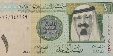 Suudi Arabistan 'ın bir riyal banknot gözleminde 7. yüzyıl altın dinarı ve Kral Abdullah bin Abdul-Aziz el-Saud portriatı yer alıyor..