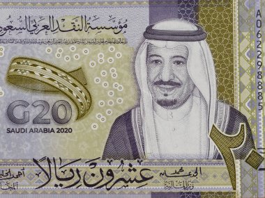 Saudi Arabia 20 riyal olive green and gray color banknote features King Salman and logo of G20 on obverse. clipart