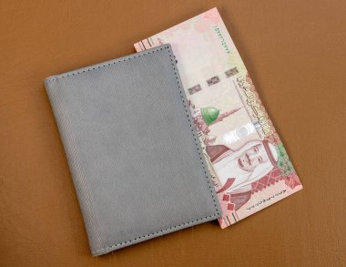 Saudi Arabia one hundred riyals banknote in a wallet clipart