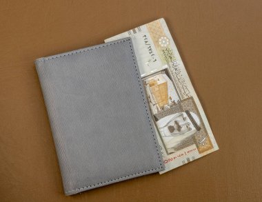 Saudi Arabia 10 riyal banknote on a leather surface clipart