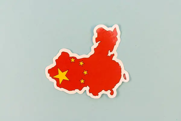 stock image China Map with National Flag Sticker on Light Blue Background with Copy Space.