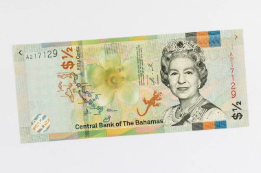 Bahamas 1/2 dollar banknotes observe feather front facing bust of Queen Elizabeth II, wearing the Burmese ruby tiara at centre right. Outline map of the Bahamas Islands and Bahama strongback flower (Bourreria succulenta) at centre isolated on white b clipart