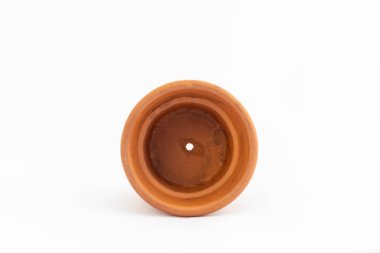 Beyaz arka planda izole edilmiş drenaj deliği olan küçük bir saksı. Terasotta tenceresi boş, yakın plan..