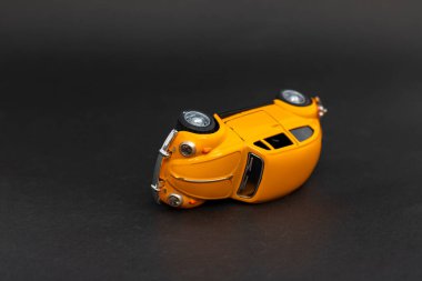 Classic toy car on black background. Car insurance concept. clipart