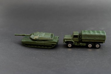 Green military tank model with military truck model clipart