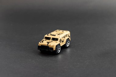 Tan Military Armored Vehicle Model on Black Background clipart