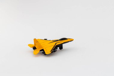 Yellow and Black Toy Jet on White Background clipart