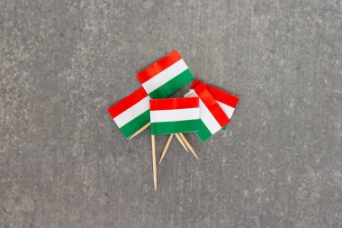 Gri yüzeyde üst üste binen Mini Macar Bayrakları Grubu