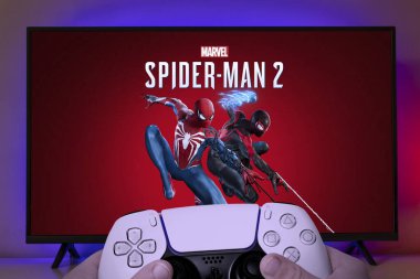 Boy playing Marvel Spider Man 2 with Playstation 5 controller, 19 Jun, 2023, Sao Paulo, Brazil. clipart