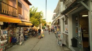 Afytos, Greece - August 31, 2022 : View of the beautiful Orthodox Church Saint Dimitri and the popular central square in the picturesque village of Afitos in Chalkidiki Greece