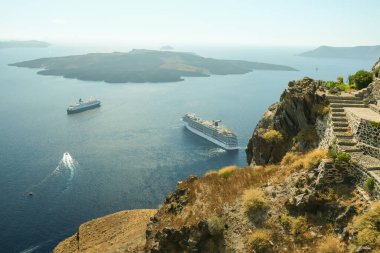 Santorini, Yunanistan - 16 Eylül 2022: Santorini Yunanistan 'daki yanardağın yanındaki iki yolcu gemisinin panoramik görüntüsü