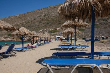 Ios, Greece - June 6, 2021 : Tourists enjoying the sandy beach of Agia Theodoti in Ios Greece