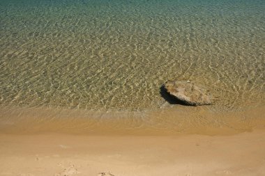 The golden sandy beach and the clear waters of Kolitsani in Ios Cyclades Greece