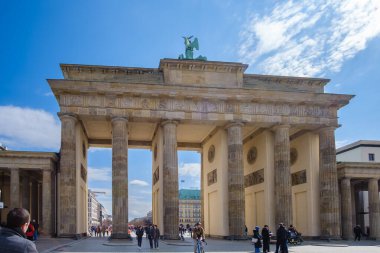 Berlin, Almanya - 18 Nisan 2023: Berlin 'deki Brandenburg Kapısı veya Brandenburger Tor manzarası ve mavi bir gökyüzü