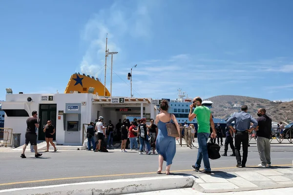 stock image Ios, Greece - May 18, 2021 : View of tourists preparing to get off and others to get on the Ferry boat at the port of Ios Greece