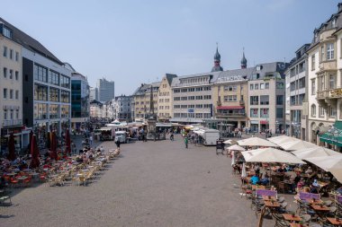 Bonn, Almanya - 22 Mayıs 2023: Bonn Almanya 'daki pazar meydanının çeşitli gıda kamyonları, kafeler, dükkanlar, restoranlar ve günün tadını çıkaran insanlarla manzarası