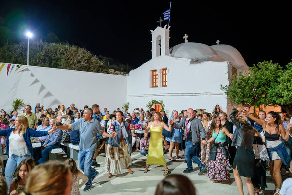 Ios, Greece - September 7, 2023 : 7, 2022 : View of a traditional festival in Ios Greece where locals and tourists dancing and celebrating the Holy Mary at the church of Agia Theodoti