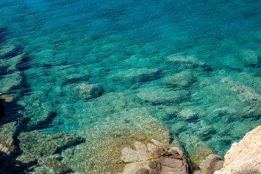 İnanılmaz şeffaf ve şeffaf turkuaz sular Ios siklades Yunanistan 'ın güzel Tripiti plajında