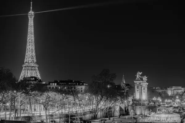 Paris, France - February 17, 2024 : Panoramic view of the illuminated Eiffel Tower and the river Seine in Paris France