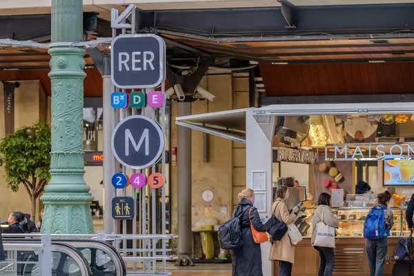 stock image Paris, France - May 17, 2024 : View of signs leading to the metro station and the RER train lines at the rail station Gare du Nord in Paris France