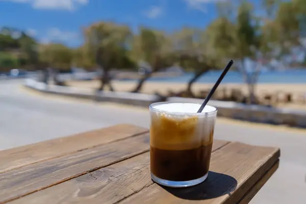 stock image Closeup view of an iced Greek coffee, also known as freddo cappuccino with a straw in Ios Greece