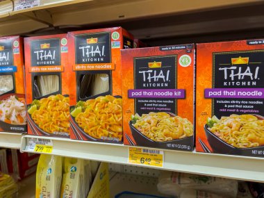 Seattle, WA USA - circa August 2022: Close up view of Thai Kitchen brand noodle kits for sale inside a grocery store. clipart