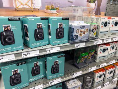 Seattle, WA USA - circa November 2022: Angled view of instant cameras for sale inside a Staples store. clipart