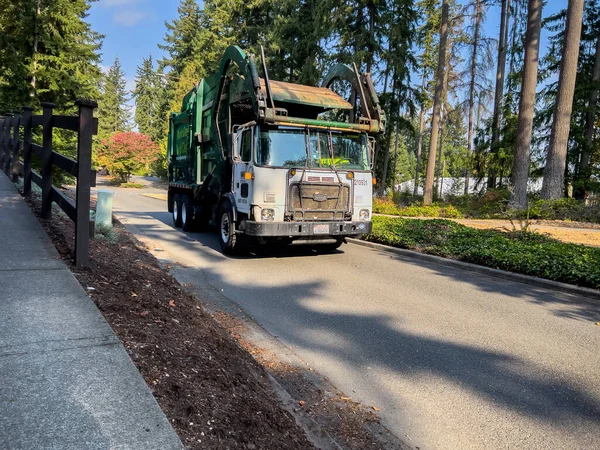 stock image Mill Creek, WA USA - circa November 2022: Wide view of trash pickup making its way in a residential neighborhood.