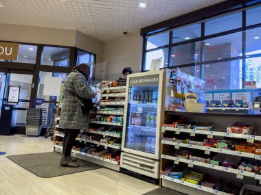 Lynnwood, WA USA - Kasım 2022: Rite Aid Eczanesi 'nde çalışan bir kadının geniş görüşü.