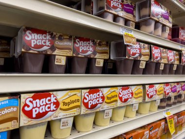 Woodinville, WA USA - circa December 2022: Angled, selective focus on Snack Pack pudding cups for sale inside a Haggen grocery store. clipart