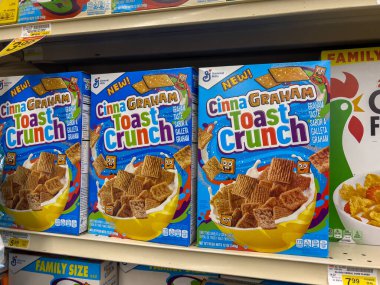 Woodinville, WA USA - circa December 2022: Close up view of Cinnamon Toast Crunch cereal for sale inside a Haggen grocery store. clipart