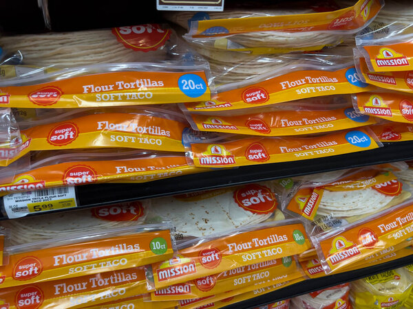 Woodinville, WA USA - circa December 2022: Selective focus on flour and corn tortillas for sale inside a Haggen grocery store.
