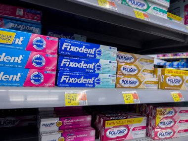 Monroe, WA USA - circa December 2022: Close up view of denture creams for sale inside a Walmart retail store.