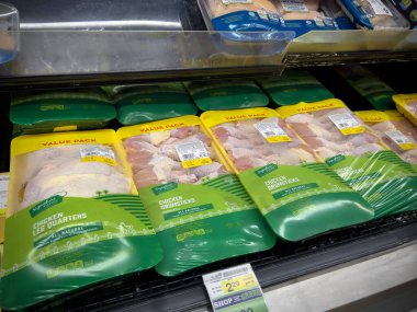 Seattle, WA USA - circa December 2022: Close up view of large packs of chicken drumsticks for sale inside grocery store.