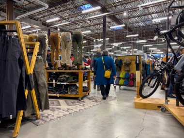 Bellevue, WA USA - circa December 2022: Wide view of people shopping inside an REI outdoors store.