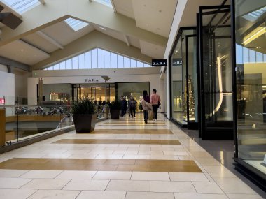 Bellevue, WA USA - circa December 2022: Wide view of people shopping inside the Bellevue Mall.