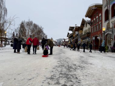 Leavenworth, WA USA - circa December 2022: Wide view of families with children exploring the downtown shopping in Leavenworth