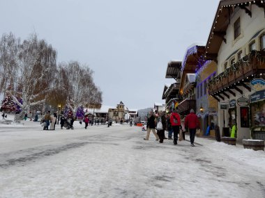 Leavenworth, WA USA - circa December 2022: Wide view of families with children exploring the downtown shopping in Leavenworth
