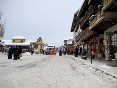 Leavenworth, WA USA - circa December 2022: Wide view of families with children exploring the downtown shopping in Leavenworth