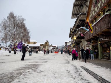 Leavenworth, WA USA - circa December 2022: Wide view of families with children exploring the downtown shopping in Leavenworth