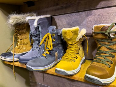 Leavenworth, WA USA - circa December 2022: Close up view of outdoor boots and shoes for sale inside a local sporting goods shop.