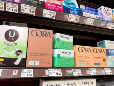 Lynnwood, WA USA - circa February 2023: Low angle view of feminine hygiene products for sale inside a grocery store.