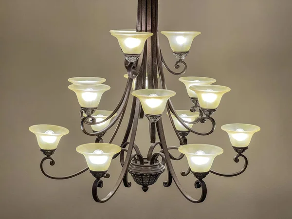 Side view of a tea light style chandelier inside a large home