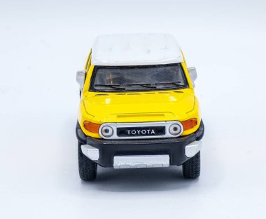 October 10, 2023 diecast car Toyota FJ Cruiser Collectible toy model car front view isolated on a white background yellow sun fire or sun fire color clipart